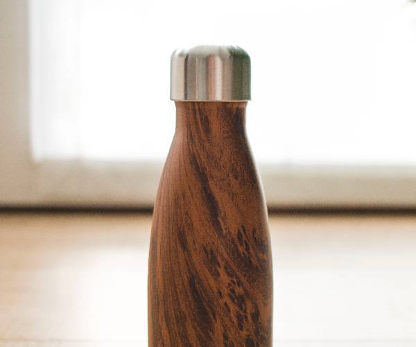 A close up of the top of a wooden bottle